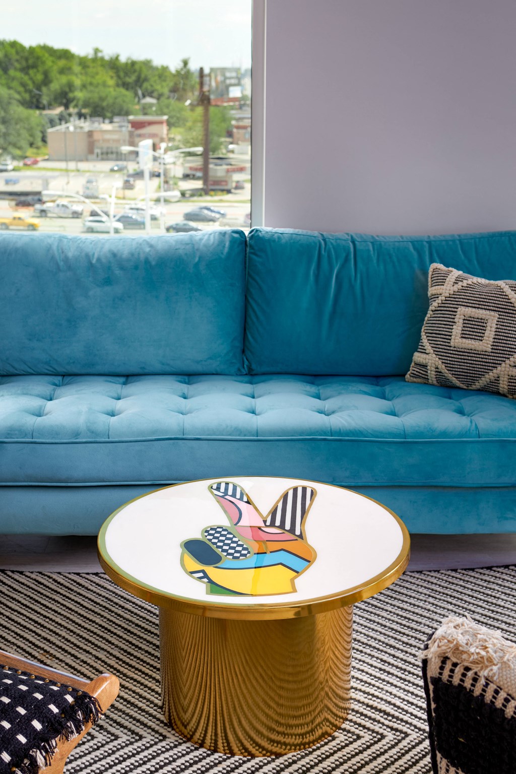 a blue couch with a round table in front of it