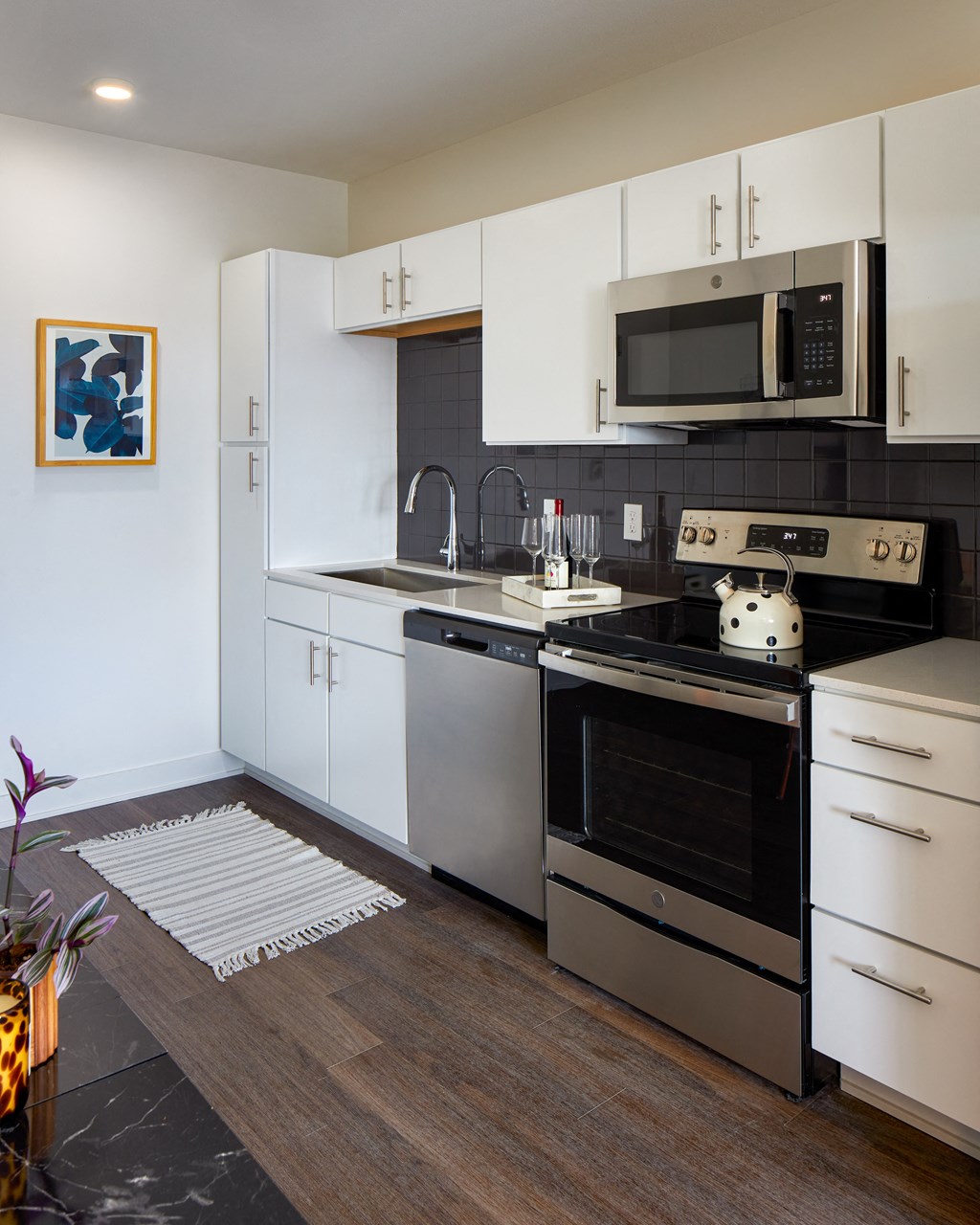 a kitchen with stainless steel appliances and white cabinets