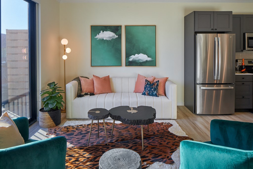 a living room with a white couch and two tables