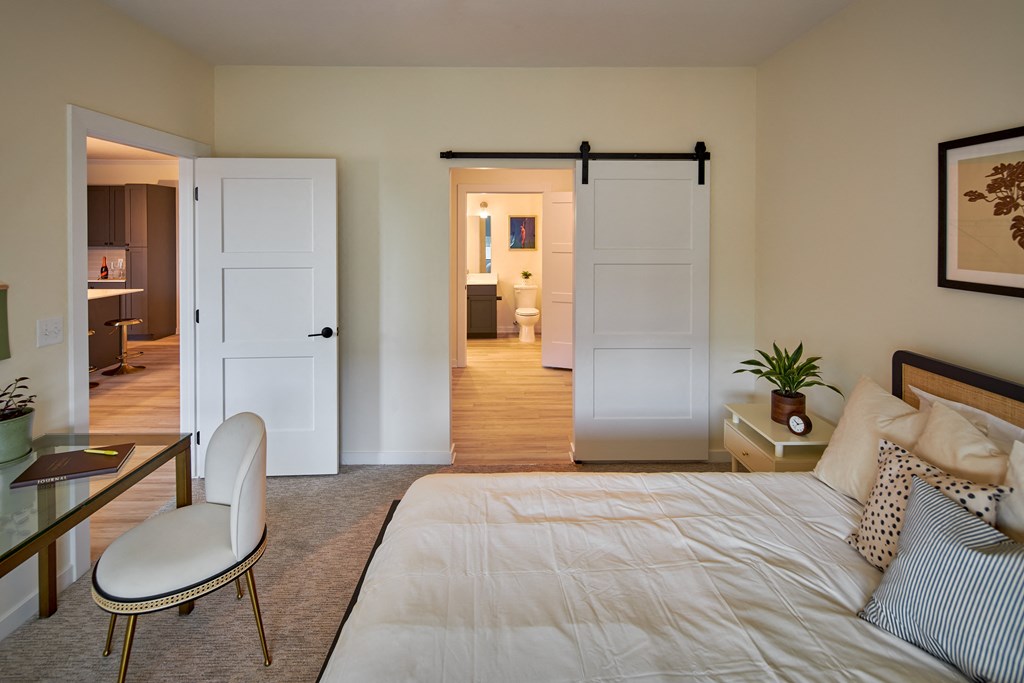 a bedroom with a bed and a desk and a closet