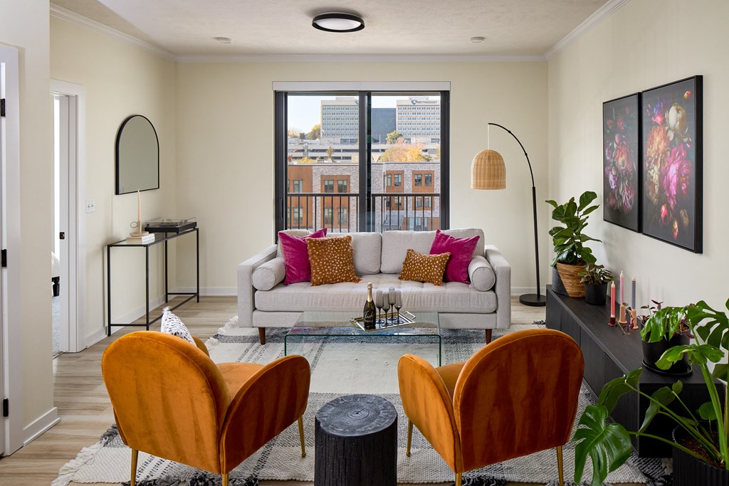 a living room with a couch and chairs