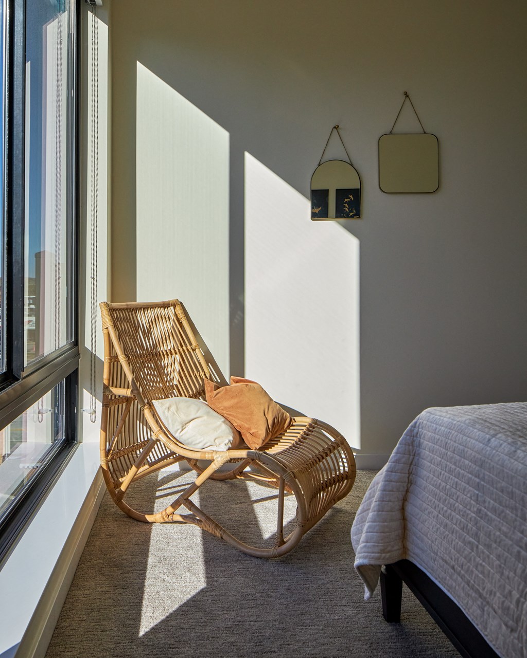 a chair in a bedroom next to a window