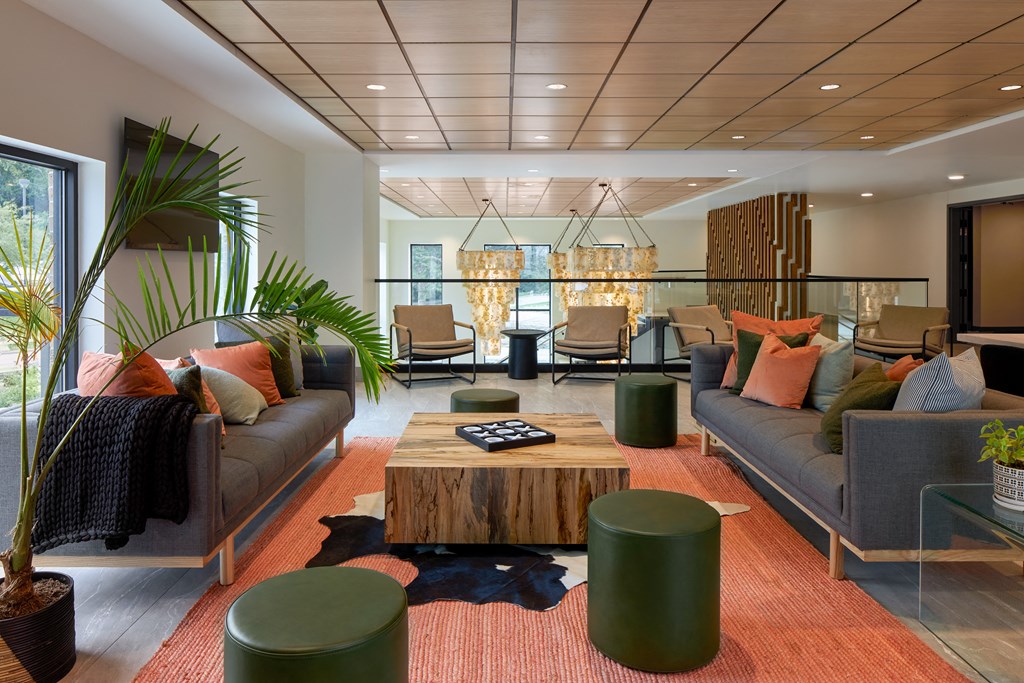 a living room with couches and chairs and a table