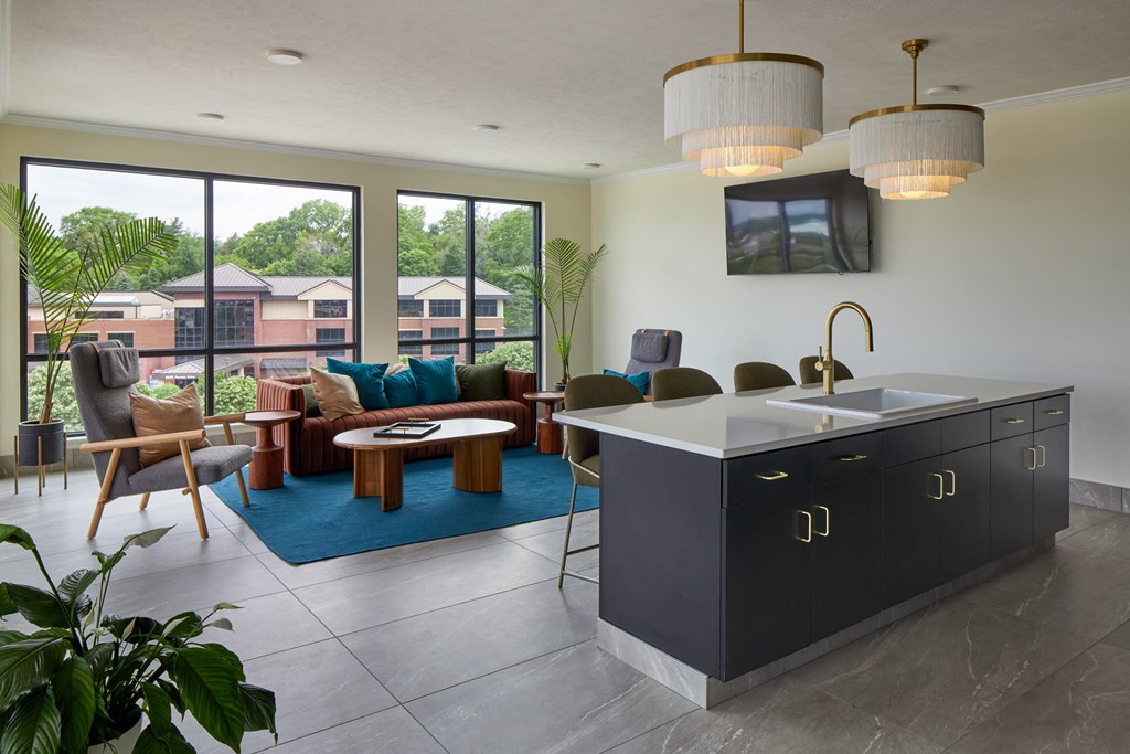 a living room with a kitchen and a balcony