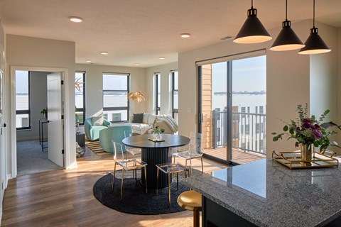A modern kitchen with a dining table and chairs.