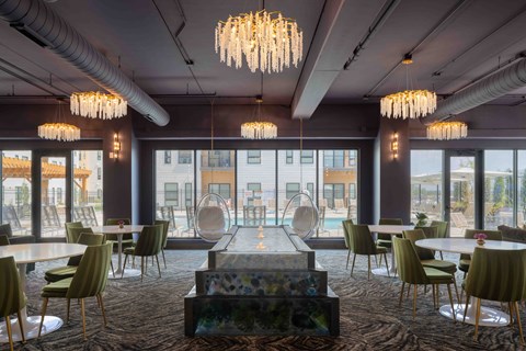 A modern dining room with a long table and chairs.