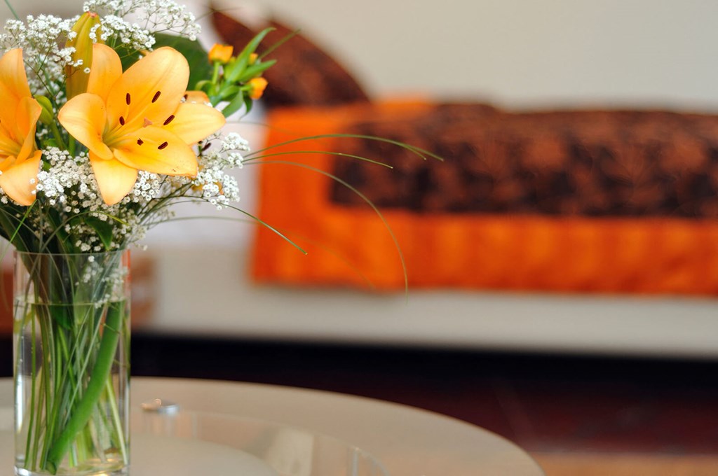 A vase of flowers sits on a table.