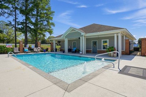 A pool in front of a house.