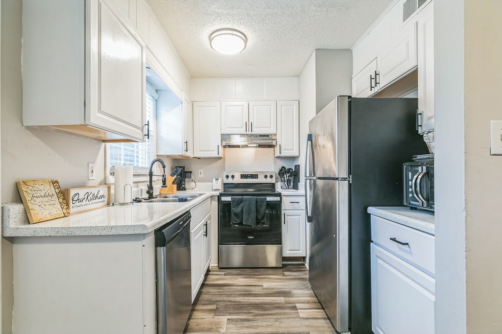 A kitchen with a black refrigerator and stove.