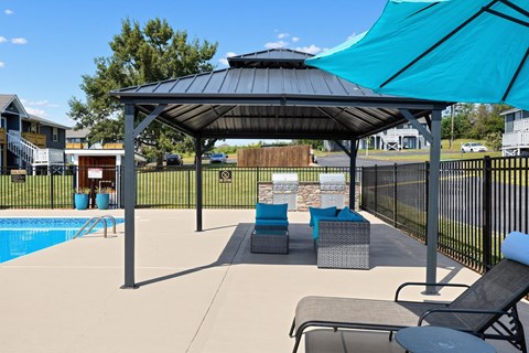 Patio with a pool and gazebo at Arbours at Victoria Place in Prattville, AL