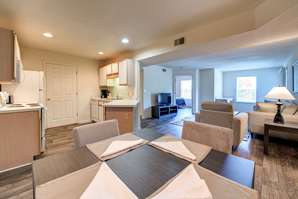 an open living room and kitchen with a dining table
