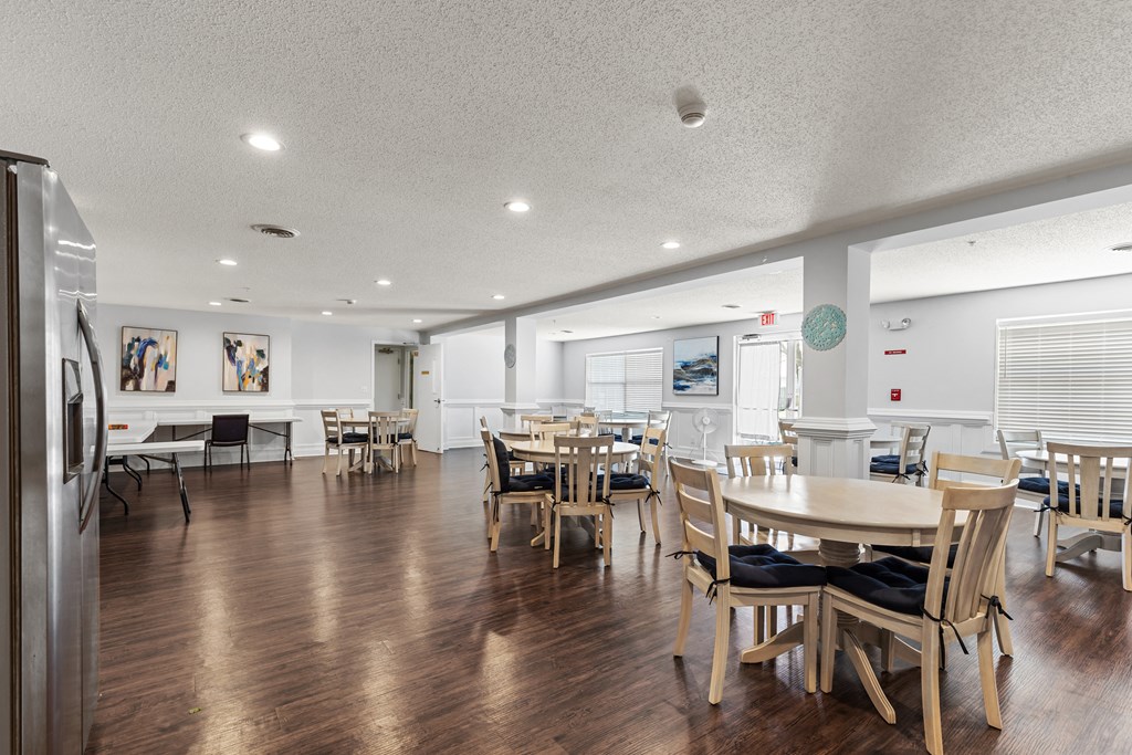 a large dining room with wooden tables and chairs