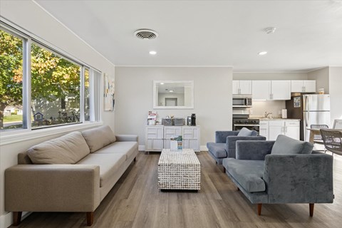 A living room with a grey couch and a coffee table.