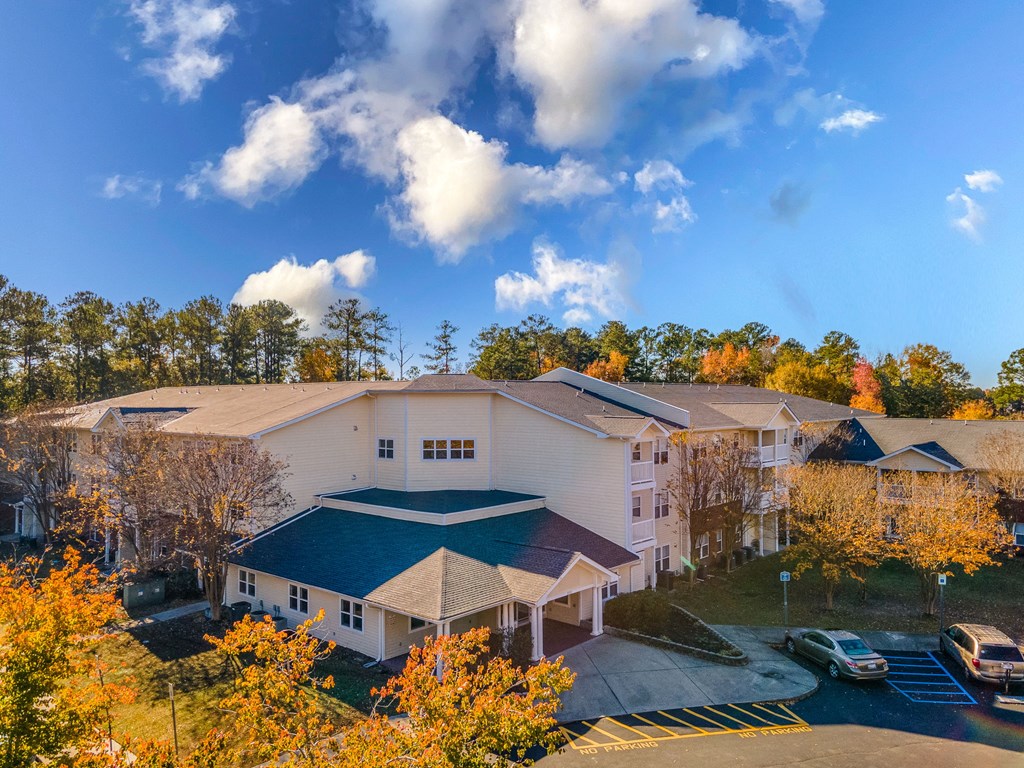 an aerial view of a large white building with a blue roof