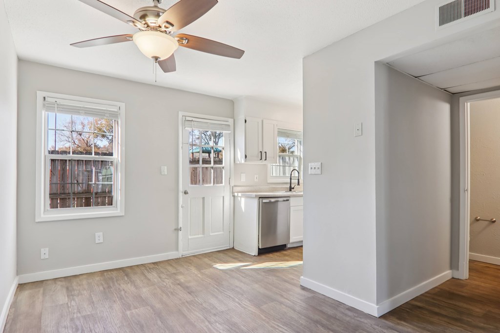 A room with a ceiling fan and a dishwasher.