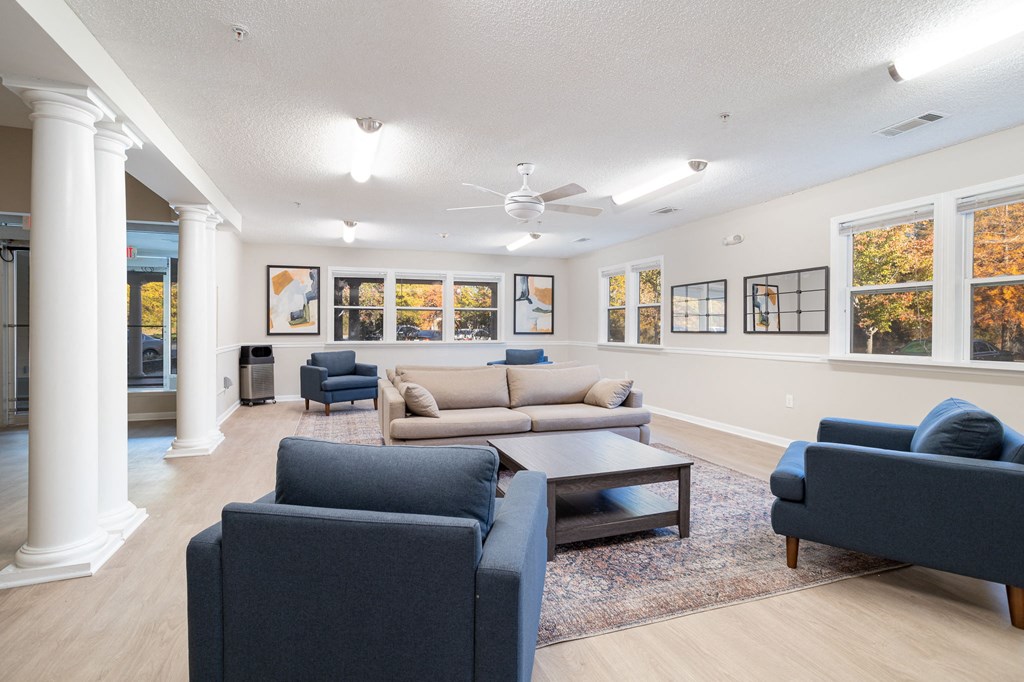 a living room with couches chairs and a coffee table