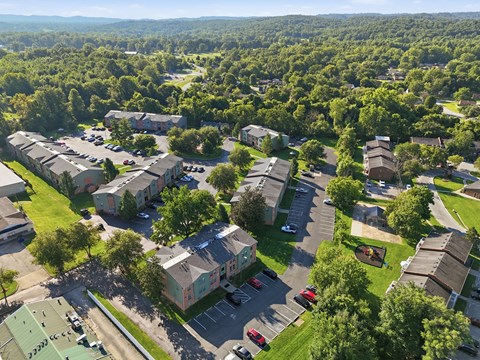 A bird's eye view of a residential area with houses and cars.