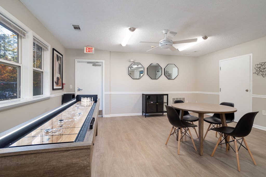 a dining room with a table and chairs