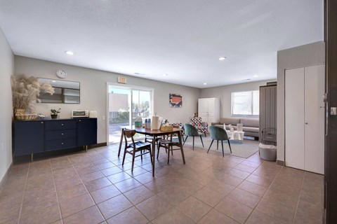 A dining room with a table set for four.