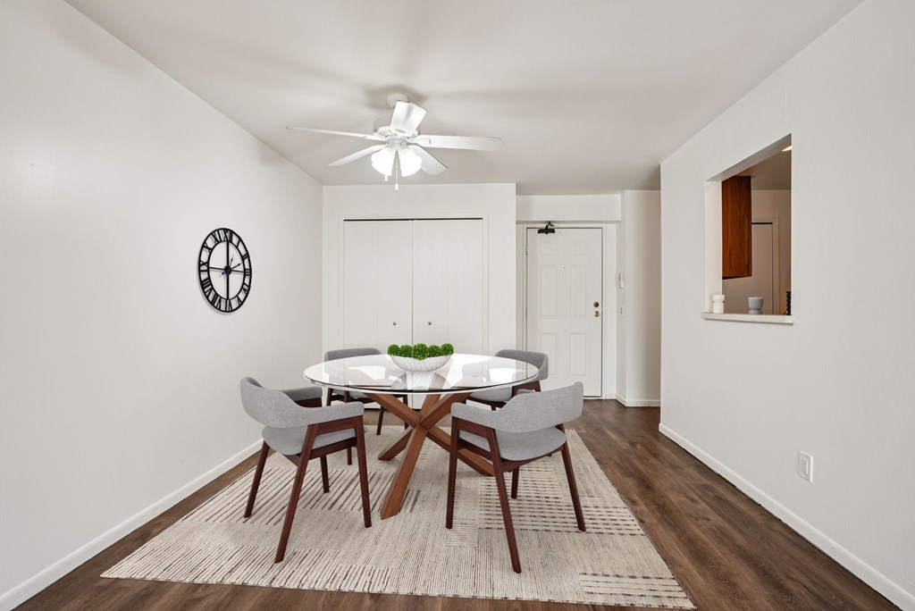 A dining room with a round table and chairs.