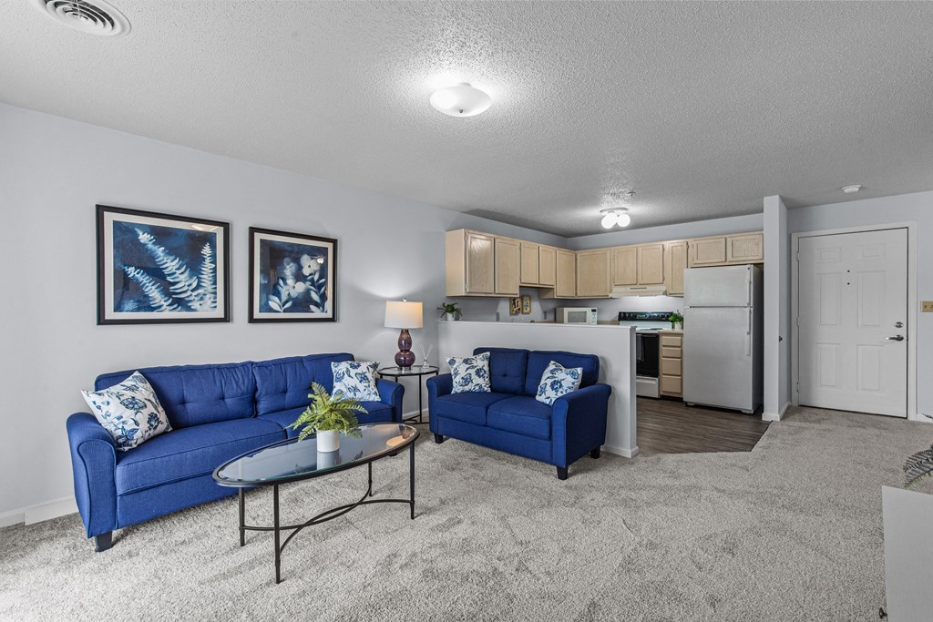 a living room with blue couches and a coffee table