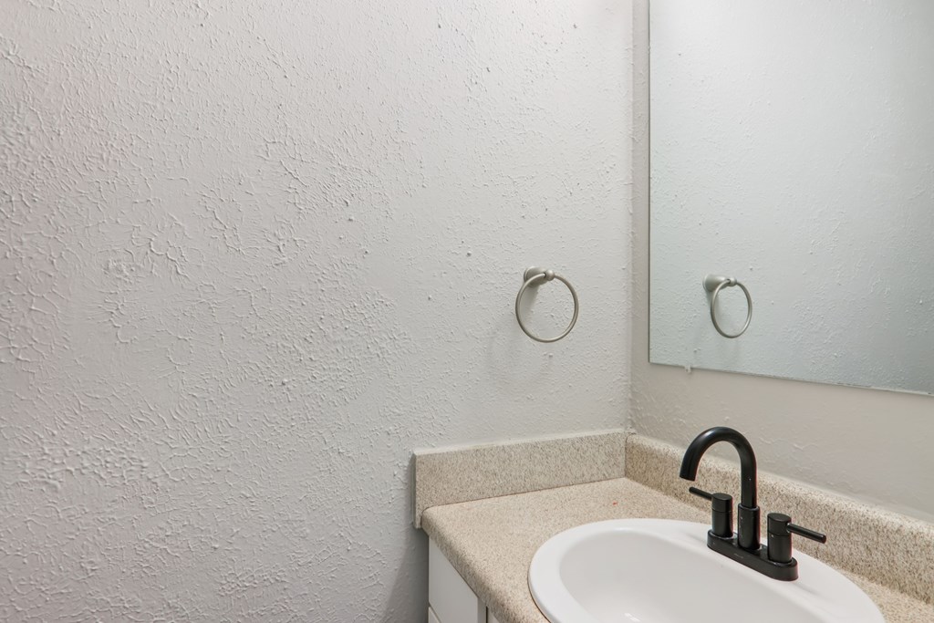 A bathroom sink with a mirror above it.