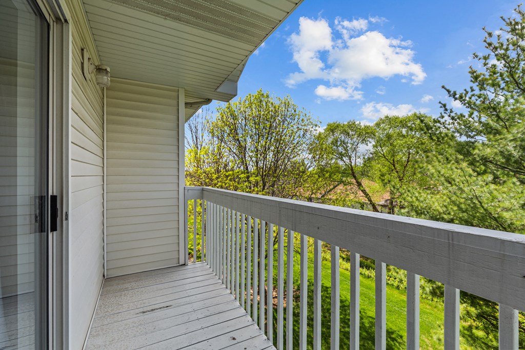 the view of the yard from the balcony of a house