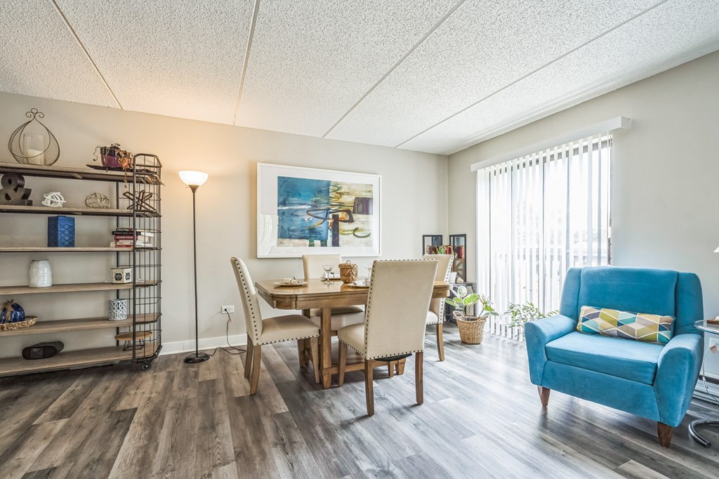 A dining room with a wooden table and chairs.