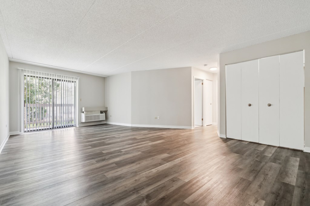 A room with wooden floors and white walls.