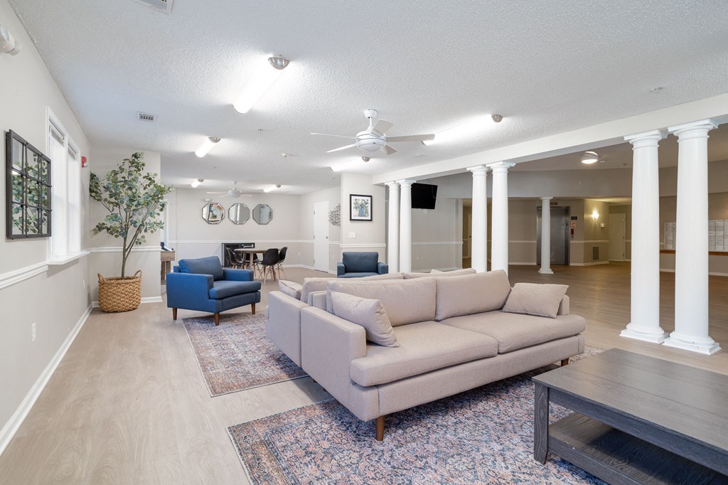 a living room with couches chairs and a coffee table