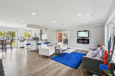 A modern living room with a bar area and a television.