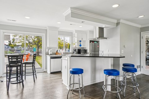 A kitchen with a bar stool and a counter.