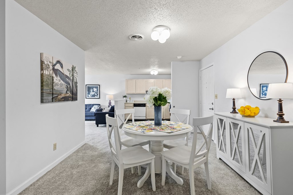 a dining room with a table and chairs and a living room