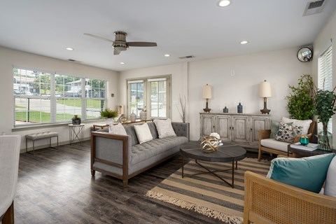 A living room with a grey couch and a wooden coffee table.