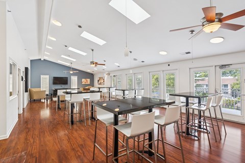 A modern dining room with a black table and chairs.