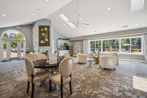 A dining room with a table and chairs.