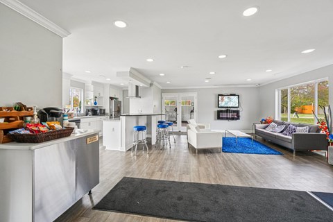A modern open plan living and kitchen area with a dining table and chairs.