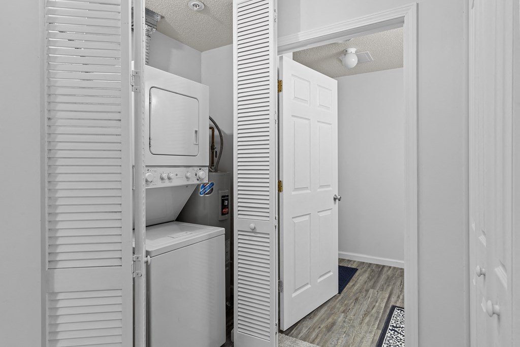 a laundry room with a washer and dryer and a white door