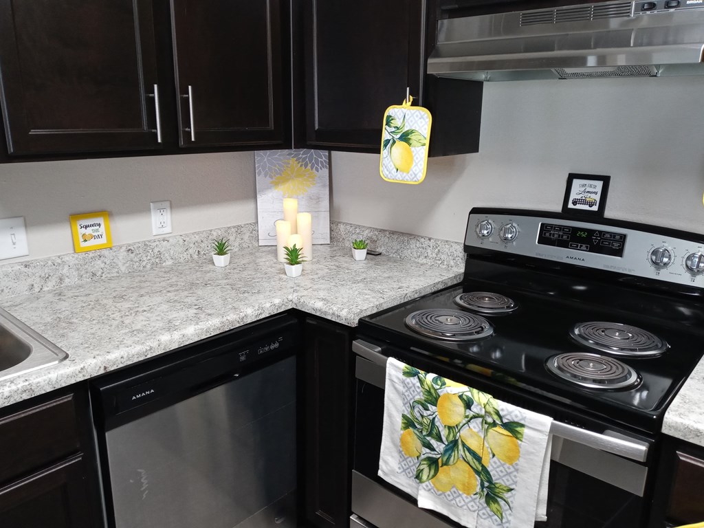 a kitchen with a stove and a counter top with towels on it