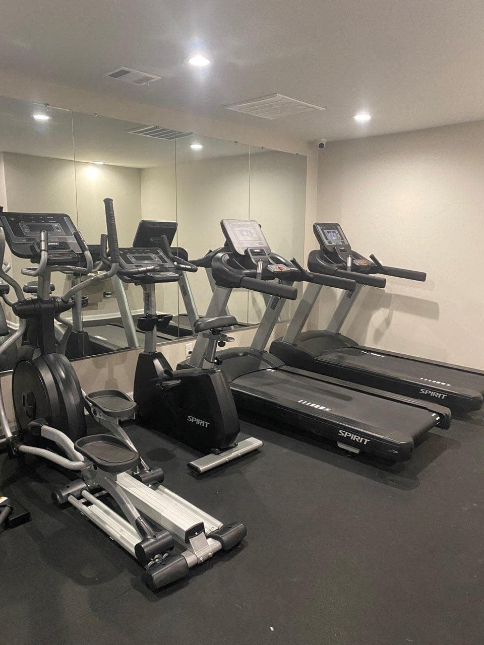 a gym with treadmills and other exercise equipment in a building