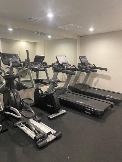 a gym with treadmills and other exercise equipment in a building