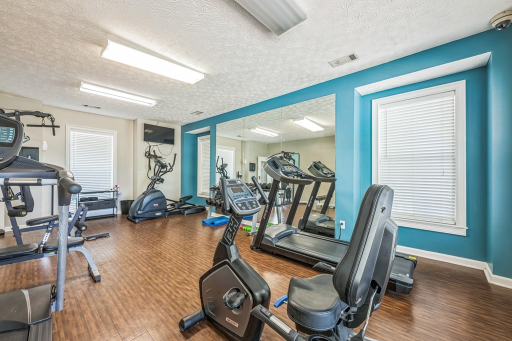 A spacious home gym with a variety of exercise equipment.