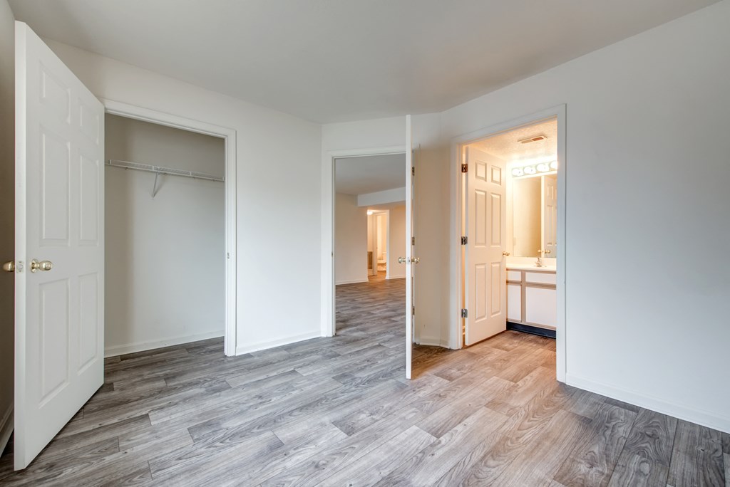 a living room with a door to a bedroom and a bathroom