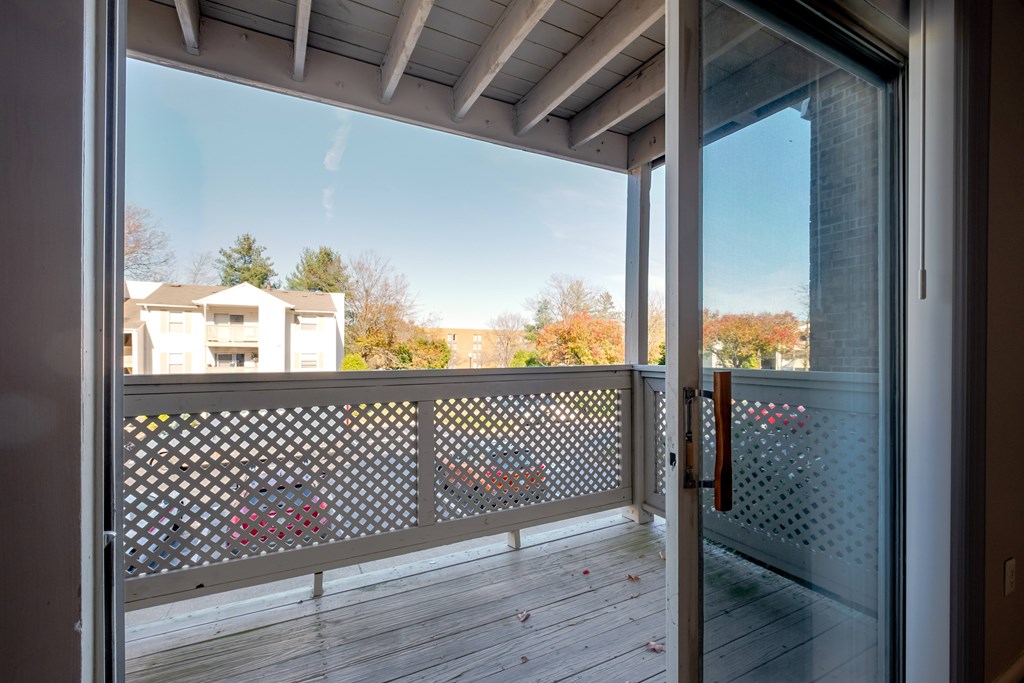 A view from a balcony looking out at a residential area.