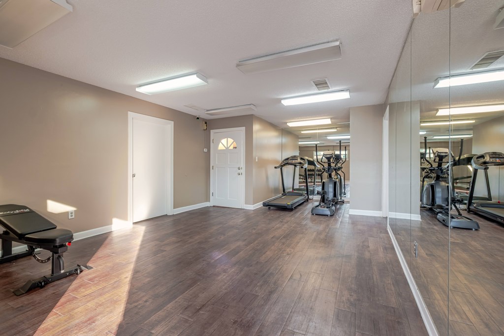 A spacious gym with treadmills and exercise bikes.