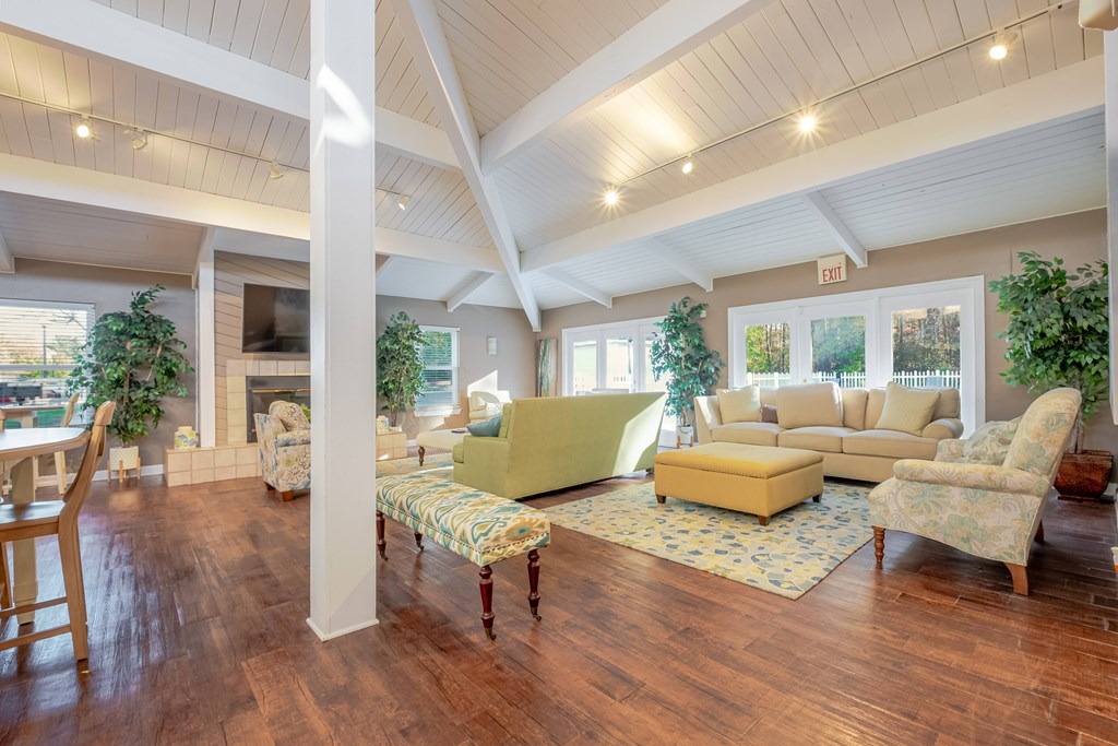 A living room with wooden floors and furniture.