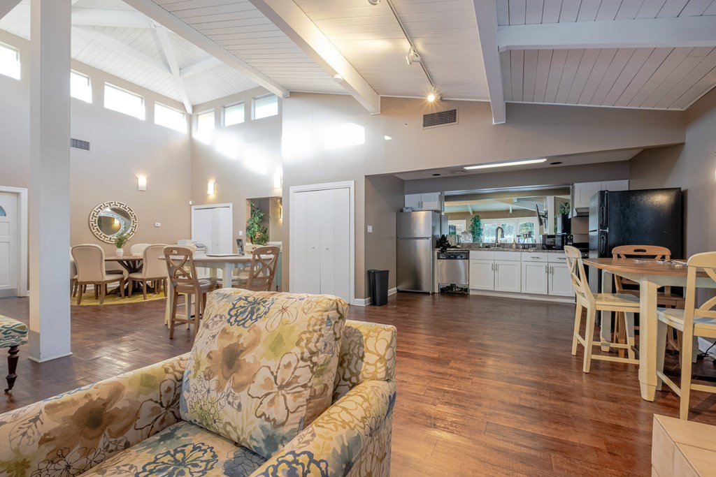 A living room with a couch and a dining table.