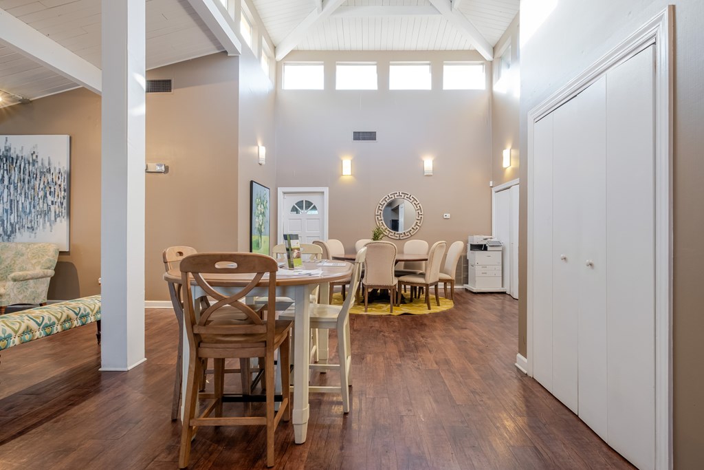 A dining room with a white table and chairs.
