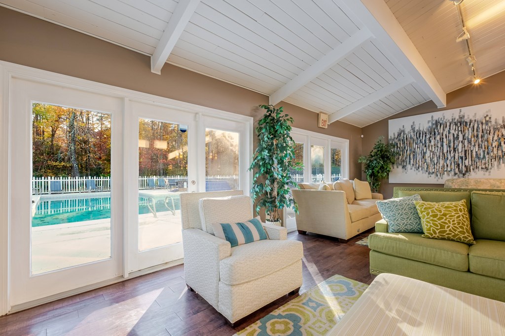 A living room with a white couch and a green couch.