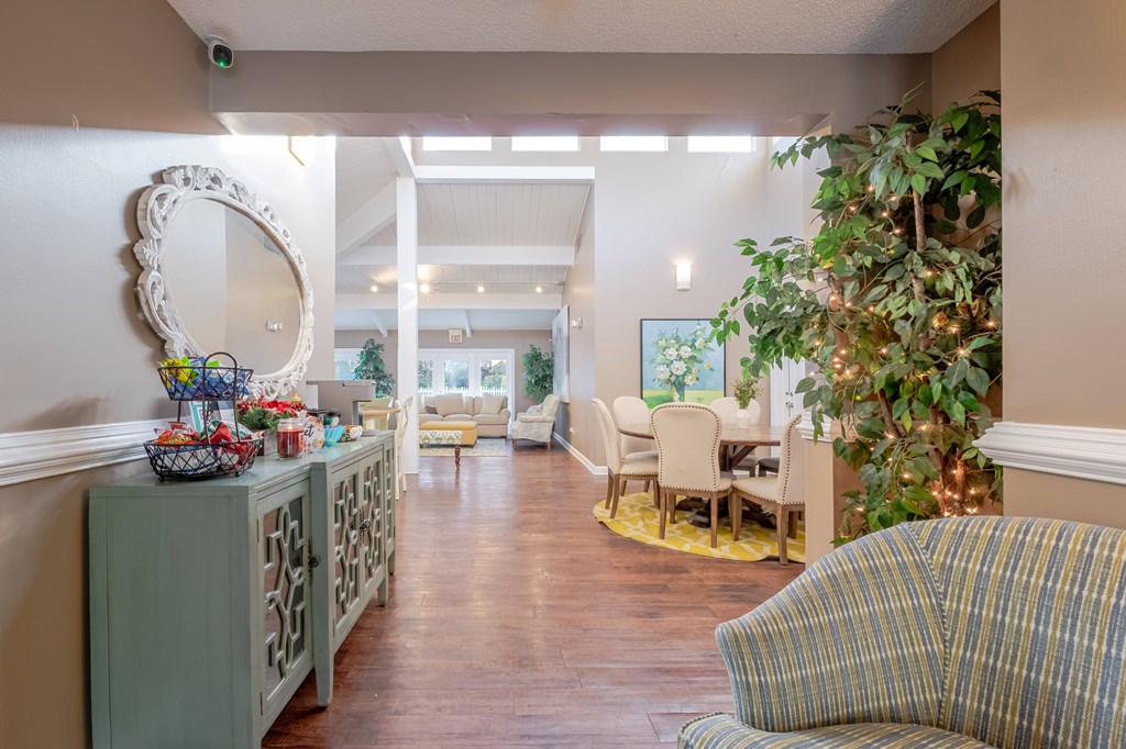 A living room with a green cabinet, a mirror, and a couch.